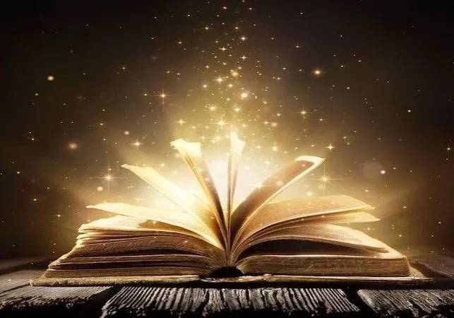 Open book glowing with magic dust.