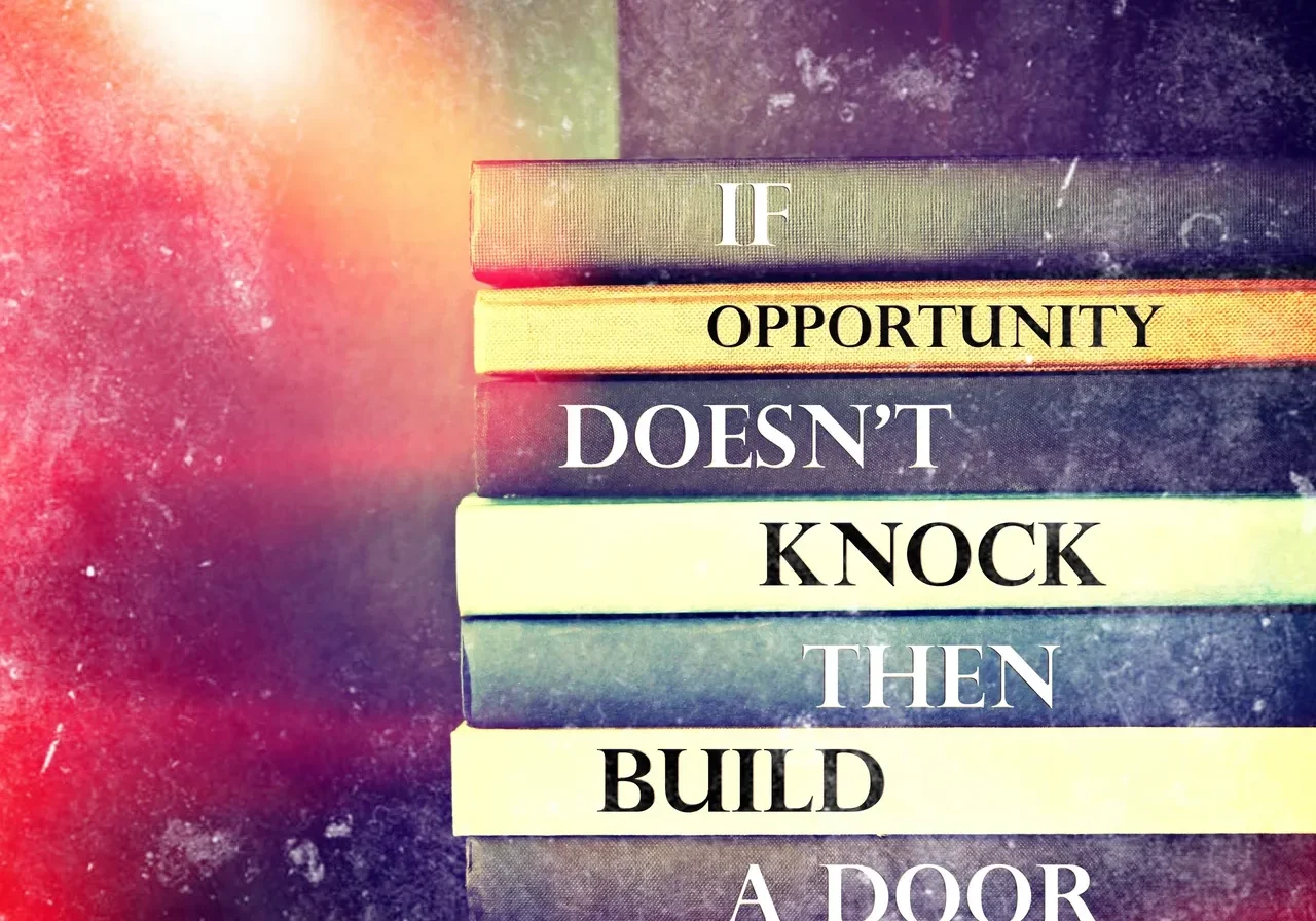 A stack of books with the words if opportunity doesn 't knock then build a door.